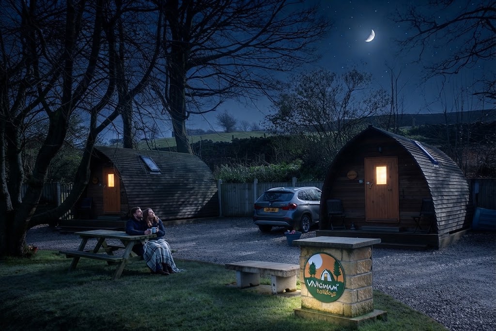 Hot tub steaming on a private deck outside a glamping cabin at dusk