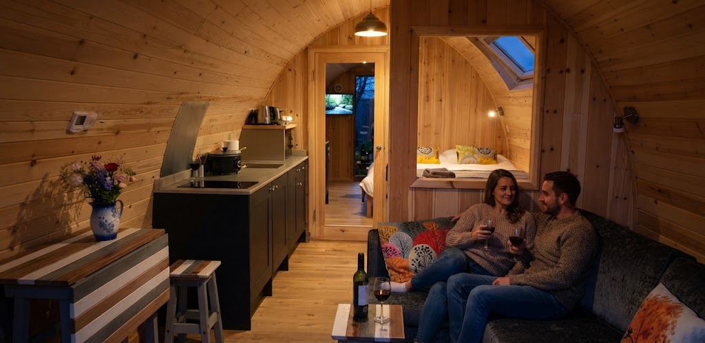 Coastal camping pods in West Wales with the sea in the distance