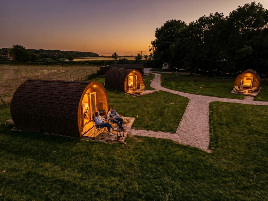 Interior of a glamping cabin with double bed and wood-panelled walls