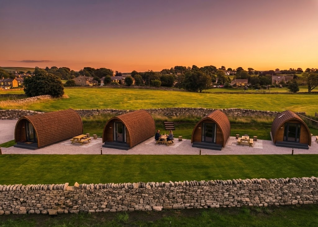 Canvas safari tent on a Welsh hillside at golden hour with mountains behind