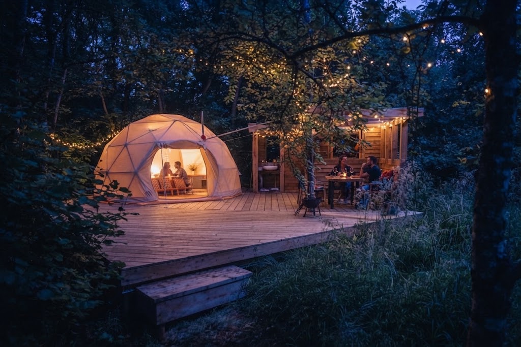 Wood-fired hot tub steaming beside a canvas yurt in a Welsh valley