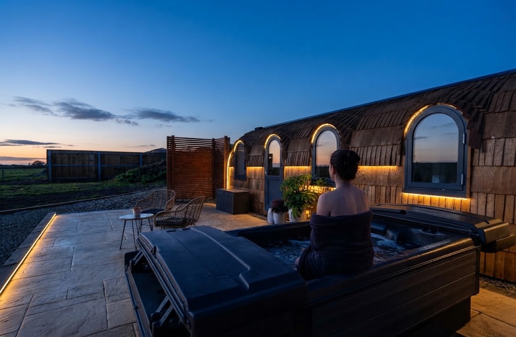Retro-styled glamping pod with vintage décor and string lights
