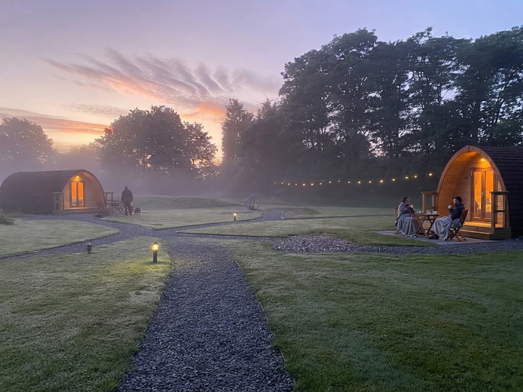 Wood-fired hot tub outside a glamping pod under a clear night sky