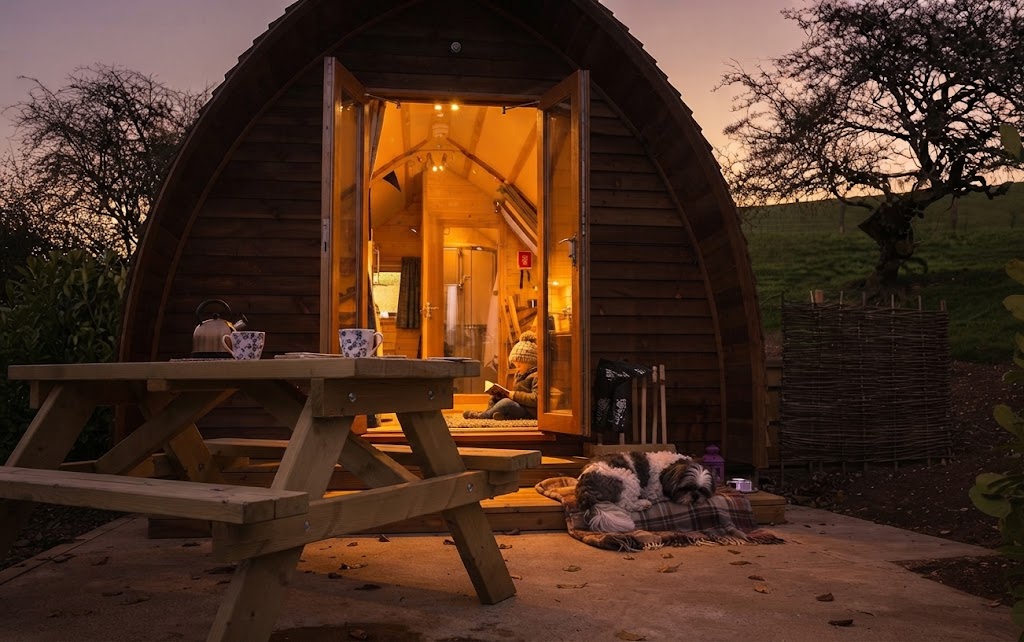 Secluded hideaway pod surrounded by trees with a private hot tub