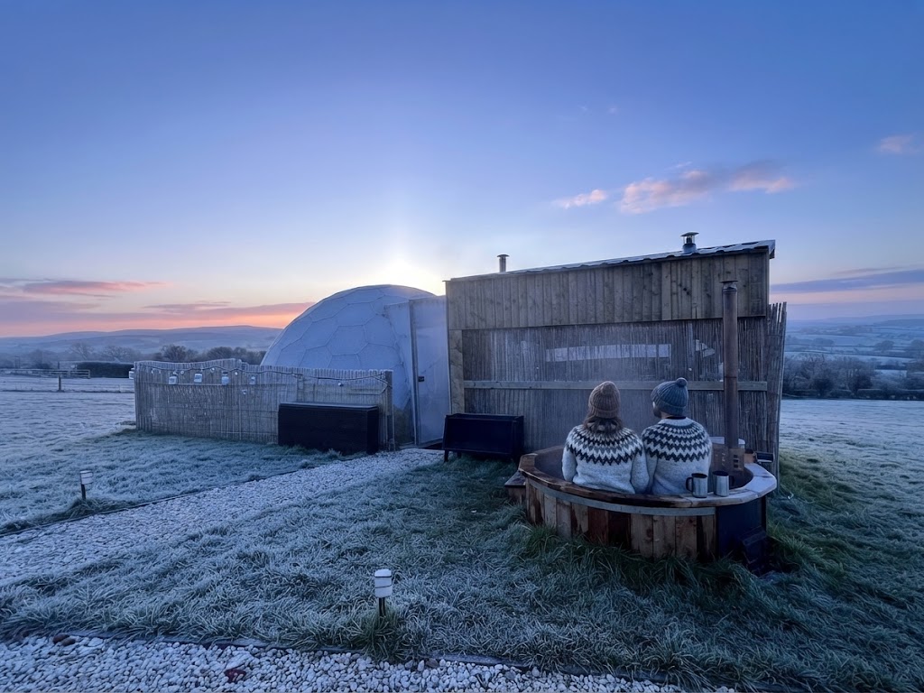 Glamping pods below the mountains of Snowdonia in autumn light